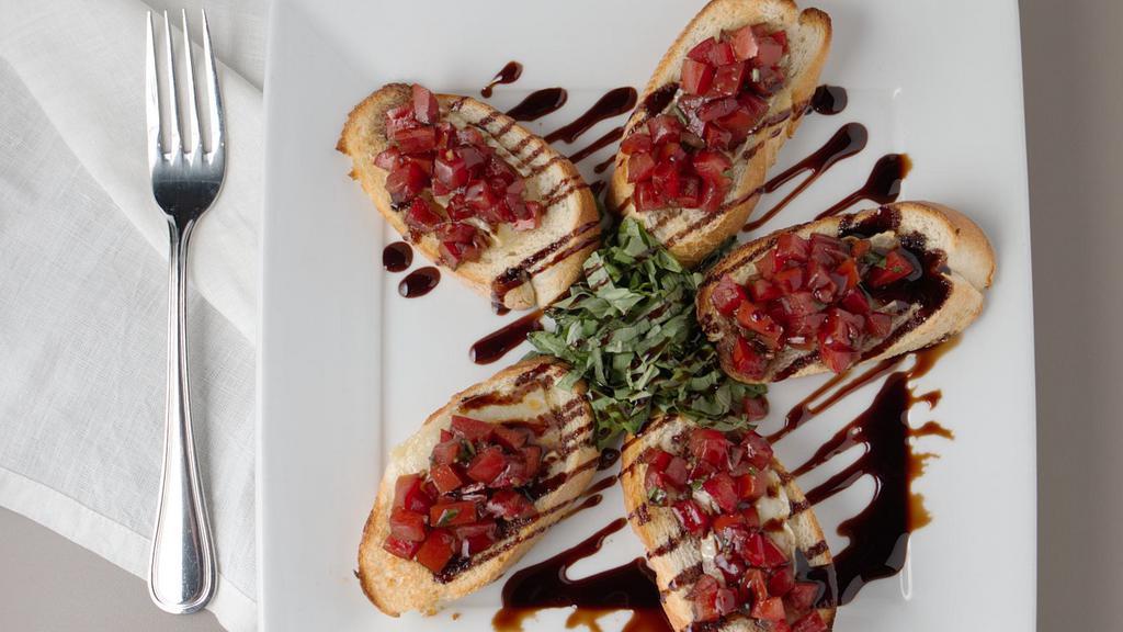 Bruschetta · Toasted Tuscan bread topped with brie, tomatoes, garlic, extra virgin olive oil, balsamic glaze and fresh basil.