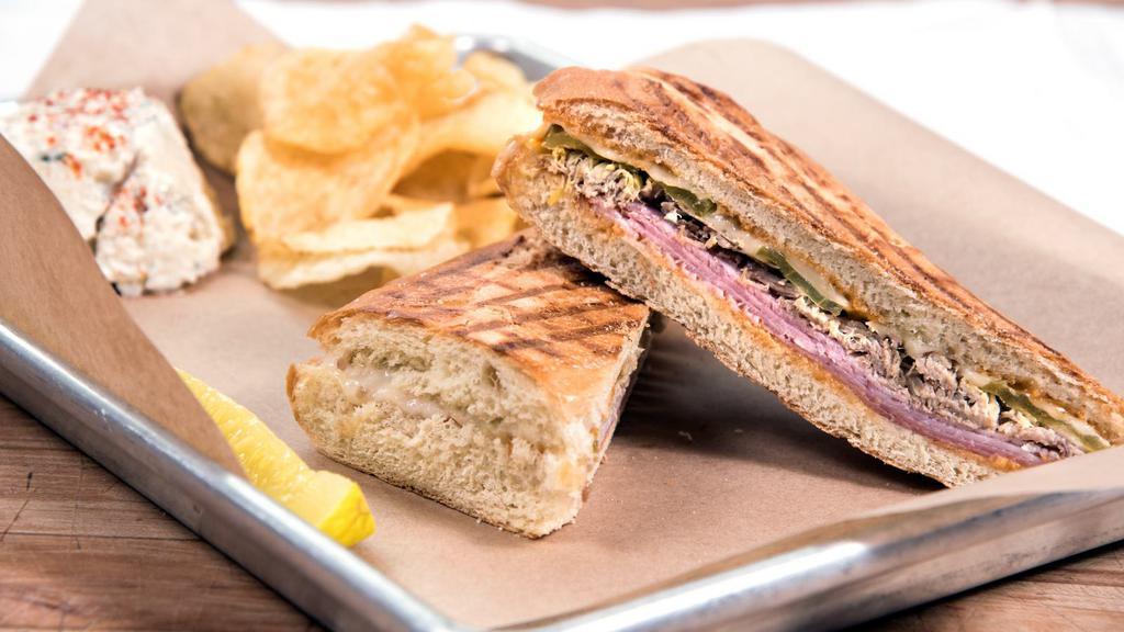 Cubano · Roasted pork, black forest ham, Swiss cheese, dill pickle chips, and chipotle mayo.