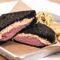 Classic Reuben · Corned beef, Swiss, sauerkraut and one,000 island dressing, served on our thick cut black pu...