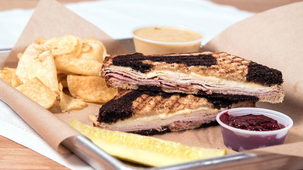 Monte Cristo · Our version - grilled not fried. Turkey, black forest ham, Swiss, dijon mustard, with a side of raspberry jam, served on our marble rye.