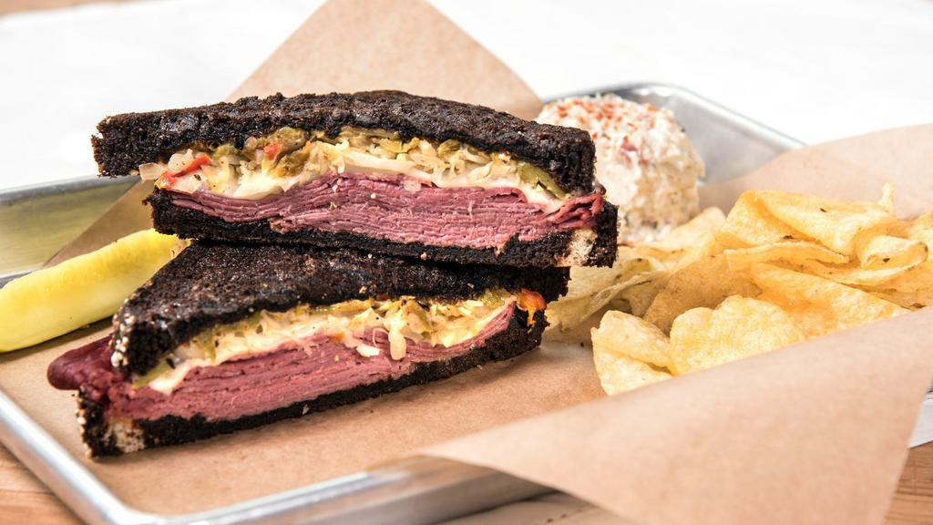 Southwestern Reuben · Corned beef, Swiss, sauerkraut, green chile and chipotle mayo served on our thick cut black pumpernickel.