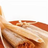 Pork Tamales · Marinated pork tamale smothered in green chili. Comes with lettuce, tomato, rice and beans.