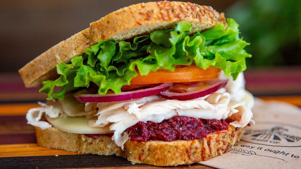 Roasted Turkey Call · Oven roasted turkey, provolone cheese with our cranberry horseradish sauce, lettuce, tomato and red onion, sandwich salt - Served on Rosemary Garlic bread.