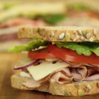 Turkey & Swiss · Oven roasted turkey, Swiss cheese, lettuce, tomato and red onion - served on Honey Whole Whe...