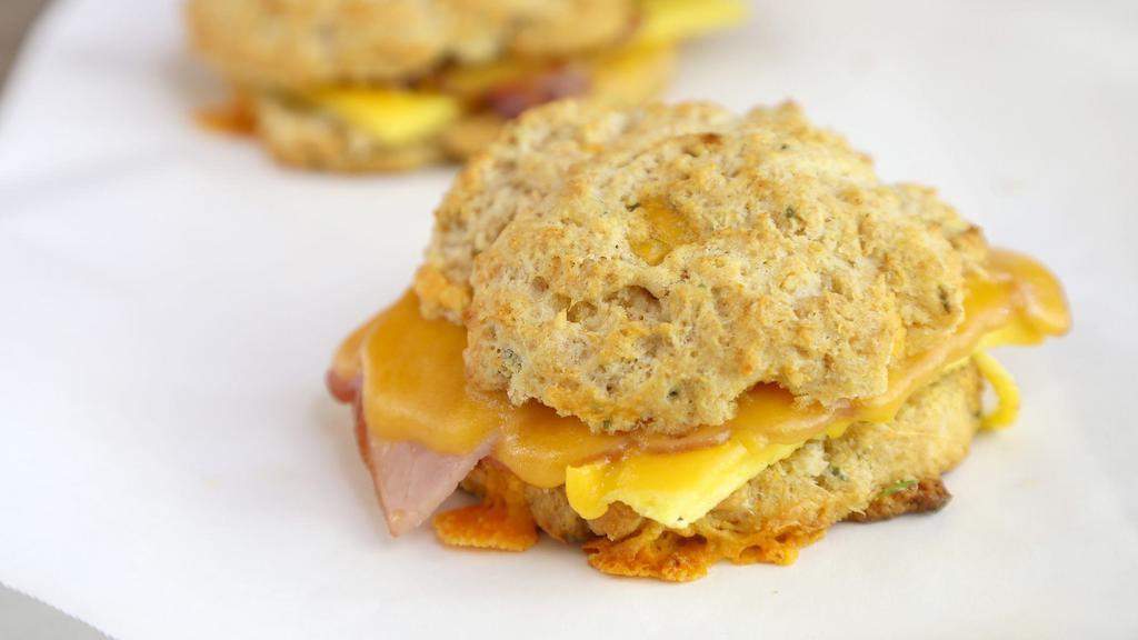 Egg And Cheese Breakfast Sandwiches · Choose from a variety of our real food, freshly made breakfast sandwiches on your choice of handcrafted bread or biscuit.  Served with our tasty breakfast sauce, cheddar, tomato,  and onion.