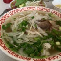 Phở Đặc Biệt (Tái, Chín, Bò Viên Gân, Sách) · Rice Noodle Soup with Rare, Well-done Beef, Meatball, Tripe, and Tendon.