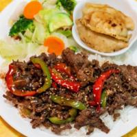 Bulgogi · Beef over rice and comes with steamed vegetables and potstickers.
