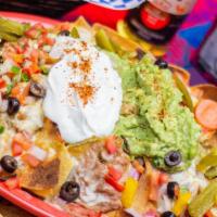 Veggie Nachos · Spicy, gluten-free. Corn tortilla wedges smothered with black beans, cheese, sour creams gua...