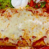 Burrito Grande · Beef, chile verde, chicken, rice and beans inside 3 large flour tortillas, smothered with es...