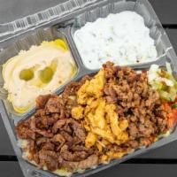 Tri- Meat Plate · Three types of meat. Chicken, lamb, beef, rice, mix salad, tzatziki, hummus mix spicy garlic...