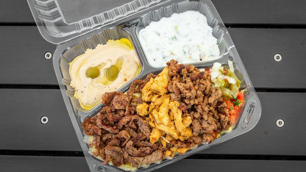 Tri- Meat Plate · Three types of meat. Chicken, lamb, beef, rice, mix salad, tzatziki, hummus mix spicy garlic sauce.