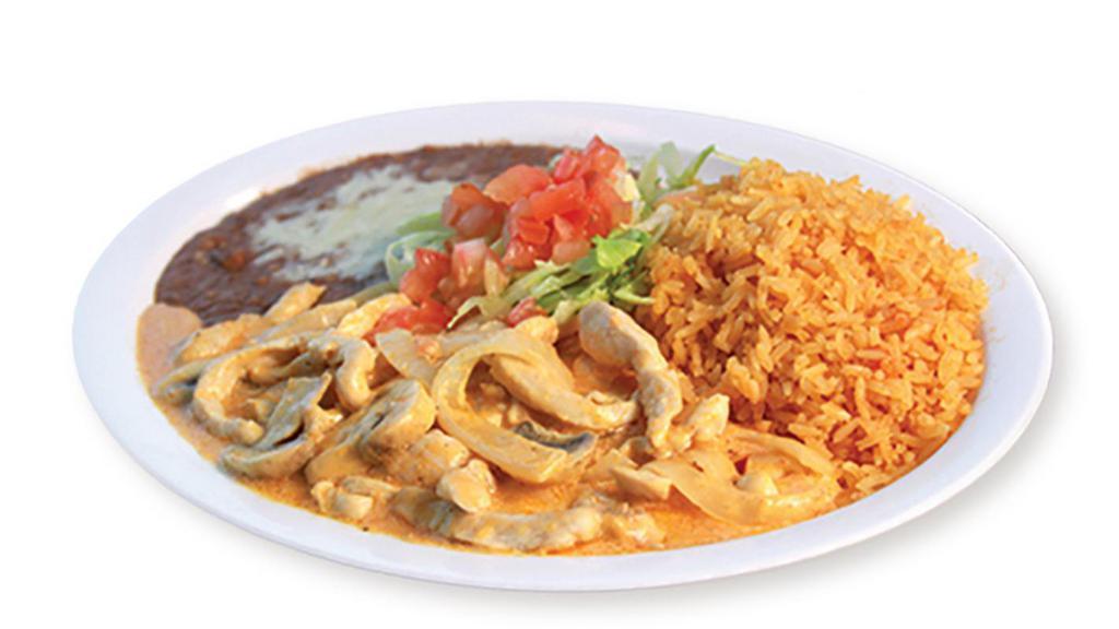 Pollo A La Crema · Chicken breast strips in a delicious Mexican cheese cream sauce with mushrooms and onions. Garnished with lettuce and tomato.