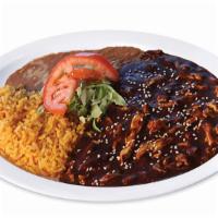 Pollo En Mole · Chicken breast strips cooked in a spicy mole sauce, mushrooms and onions. Garnished with let...