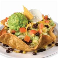 Sureño Taco Salad · Tortilla shell with refried beans, choice of meat, lettuce, onions, cheese, corn, guacamole,...