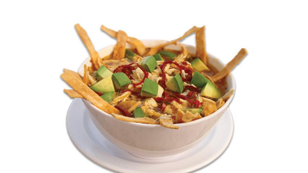 Sopa De Tortilla · Our own recipe includes shredded chicken, tortilla chips and spices in a delicious chicken broth. Topped with diced avocado and sour cream. No rice and beans included. No Rice, bean or tortilla on the side.