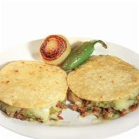 Single Mulita · Two soft corn tortillas with cheese, your choice of meat, onions, cilantro, salsa, and guaca...