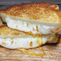 The Classic Grilled Cheese · Sharp yellow cheddar, Havarti and Monterey Jack cheeses on Sourdough bread.
