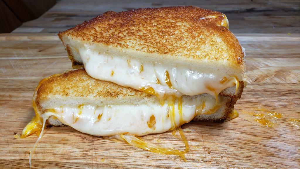 The Classic Grilled Cheese · Sharp yellow cheddar, Havarti and Monterey Jack cheeses on Sourdough bread.