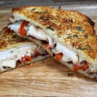 The Chipotle Chicken · Aged Swiss and Havarti cheeses with Diced Grilled Chicken, Onion, and Red Bell Peppers on So...