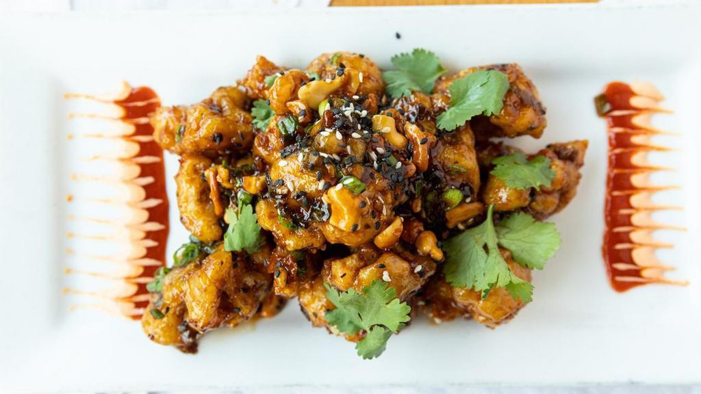 Cracklin' Spicy Cauliflower · Fried sesame tempura battered cauliflower tossed in a Spicy Black Bean sauce. Topped with green onions and chopped cashews. Served with Sriracha aioli.