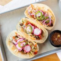 Carne Asada Street Tacos · Grilled tri-tip, salsa roja, chipotle Napa slaw, Cotija, pickled radish, jalapeño, pico de g...