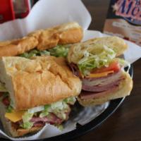 The Paul Bunyon (12 Inch) · 12 ounces of meat bologna, ham, turkey, salami, choice of cheese, lettuce, tomatoes, onion a...
