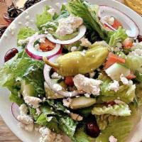 Greek Salad · A fresh Greek salad contacting lettuce, tomato, cucumbers, red onions, pepperoncini, and oli...