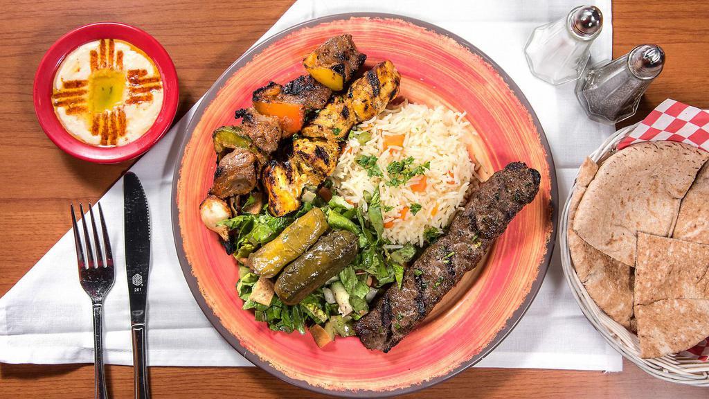 Mix Match · Any three kebab skewers with rice, spiced onions, tomatoes, hummus, and pickles. Served with dolmas and fattoush salad. Choice of hummus or baba ghanoush and pita or tortilla.