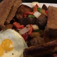 The Sampler · Two eggs prepared to order served with two pieces of bacon, sausage links and ham, hash brow...