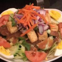 Thai Salad · Fried tofu, lettuce, tomatoes, cucumber, onion, cilantro, carrots with peanut sauce dressing.