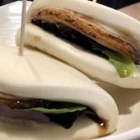 Cha-Shu Steamed Bun (2) · Seared pork belly and spring mix sandwiched in a fluffy bun.