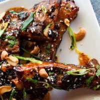 Crispy Pork Ribs · Hoisin bbq glazed pork ribs, slow-braised to perfection, and topped with crushed cashews, ci...
