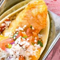 Fish Tacos · Three lush tacos loaded with beer battered cod, pickled red onion, napa slaw, tomatoes, chip...