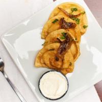 Pierogies · Tincup grilled onions, sour cream, green onions.