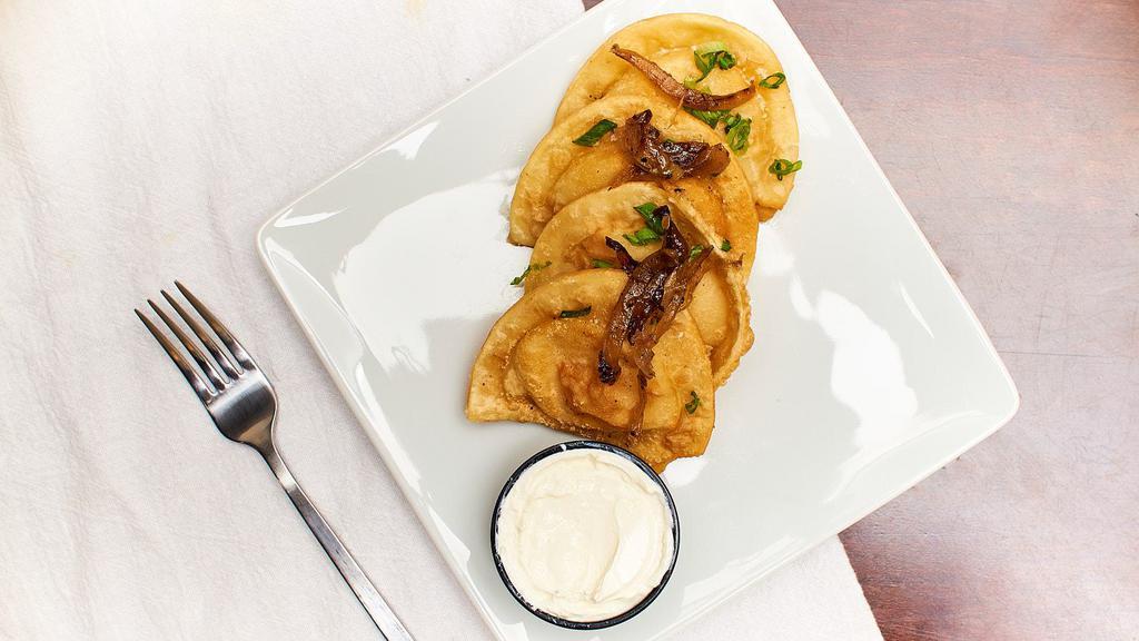 Pierogies · Tincup grilled onions, sour cream, green onions.
