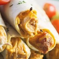 Chicken Taquitos · Deep-fried flour tortillas filled with fresh tasty chicken, garnished with lettuce, guacamol...