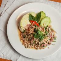 Larb Salad Chicken · Ground chicken with greens, red onion, cilantro, basil, rice powder, and lime juice.