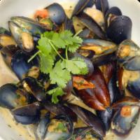 Goan Style Mussels · Mussels sautéed in a white wine base coconut curry sauce with roasted garlic, fresh herbs, c...