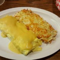 Mondo Country Omelette · Bacon, ham, sausage, green peppers and onions topped with hollandaise sauce.
