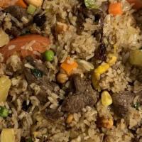 Pineapple Fried Rice · Jasmine rice with egg, pineapple, cashew nuts, raisins, onions, and tomatoes, diced vegs(pea...