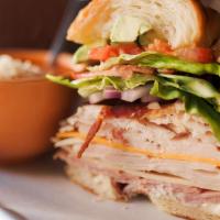 California Club · Cherrywood smoked ham, Swiss, oven-roasted turkey, bacon, cheddar, sliced chicken breast on ...