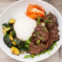 Korean Beef Bento · Marinated Korean beef bowl, kimchi, rice, zucchini, and sesame.