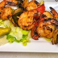 Grilled Shrimp · Two skewers of shrimp mixed with onions and bell peppers, grilled and topped with bbq sauce.