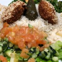 Vegetarian Lovers · A combination plate of hummus, baba ganoush, grape leave (one), falafels (two), rice. Taboul...