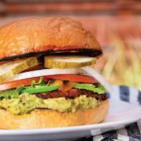 The El Chilango · 1/3 lb. patty with cheddar cheese, fresh, jalapeño, and house-made guacamole. Topped with le...