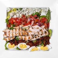 Cobb Salad · Gluten-free. Our house salad topped with grilled chicken, tomato, fried prosciutto, eggs, an...