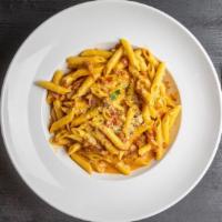 Penne Alla Vodka · Penne pasta tossed in vodka pink sauce with onions & prosciutto.