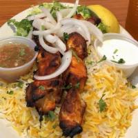 Chicken Kabob Platter · White meat chicken cubed and served with basmati rice, topped with parsley and salad.