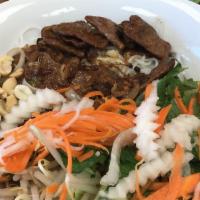 Vermicelli Soy Beef Noodle Bowl · Vermicelli noodles served with soy beef, onions fresh herbs, pickled radish and carrots, bea...