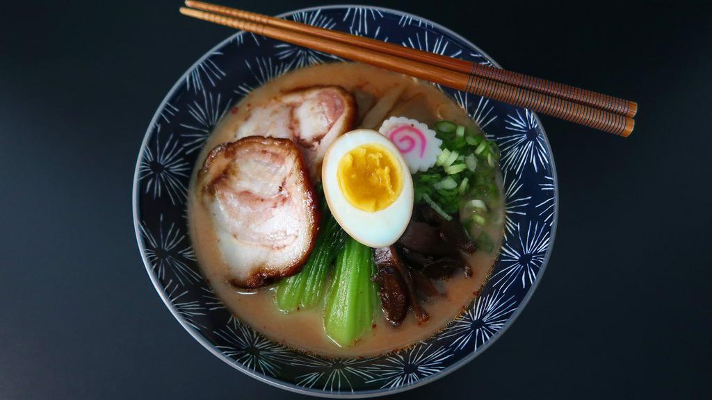 Spicy Miso Ramen · Roasted pork, boiled egg, bok choy, bamboo shoots, shiitake mushroom, enoki mushroom, fresh green onion and fish cake.